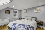 Bright bedroom with a skylight and a queen bed 